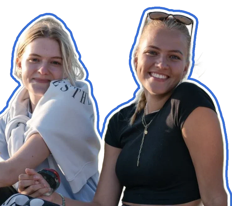Two women smile at the camera.