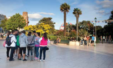 Students talk in a group in Bournemouth Town Square