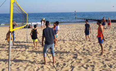 Students playing beach volleyball