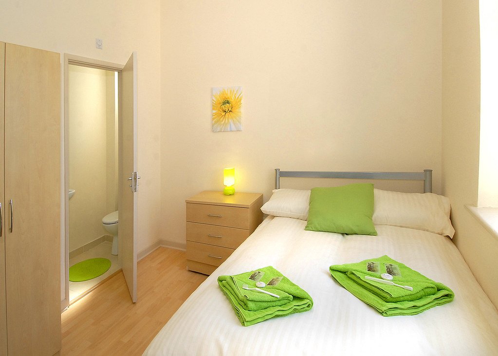 Residence with white and green bedding