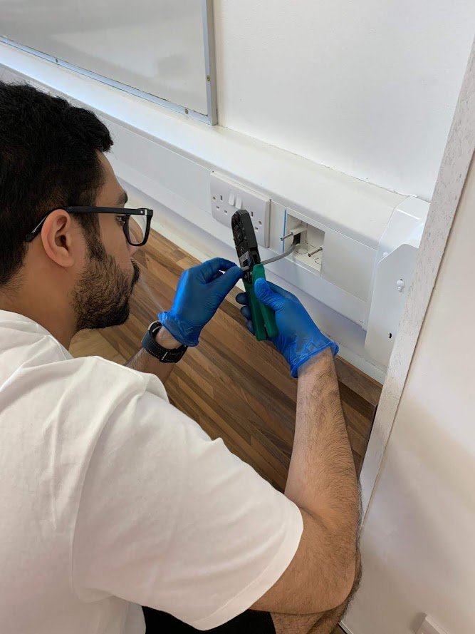 A student stripping the wire as part of an electronic module on their course